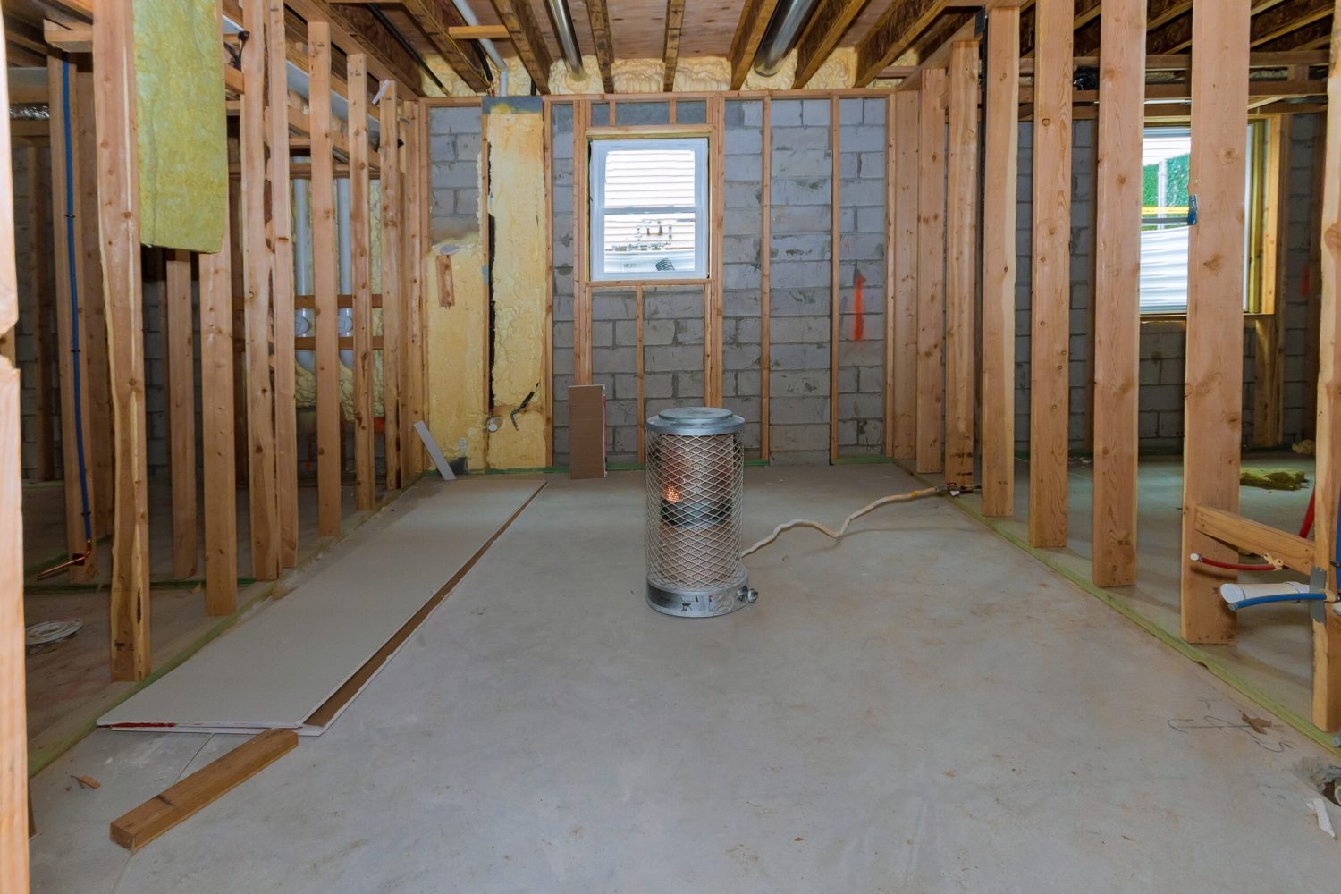 An unfinished basement being framed for a renovation