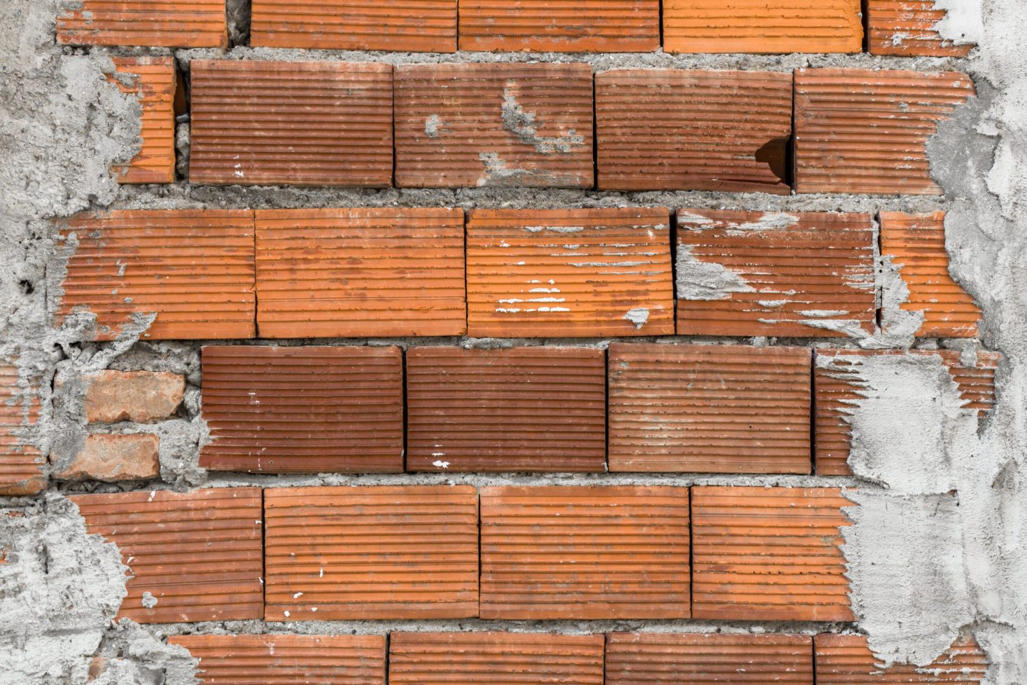 A wall of large bricks laid in irregular courses