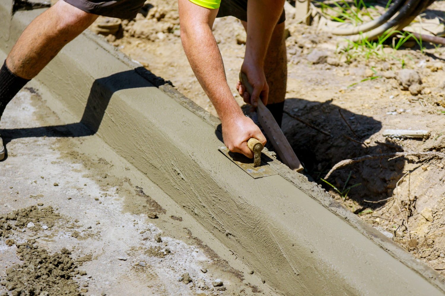 A concrete sidewalk and curb being formed and poured