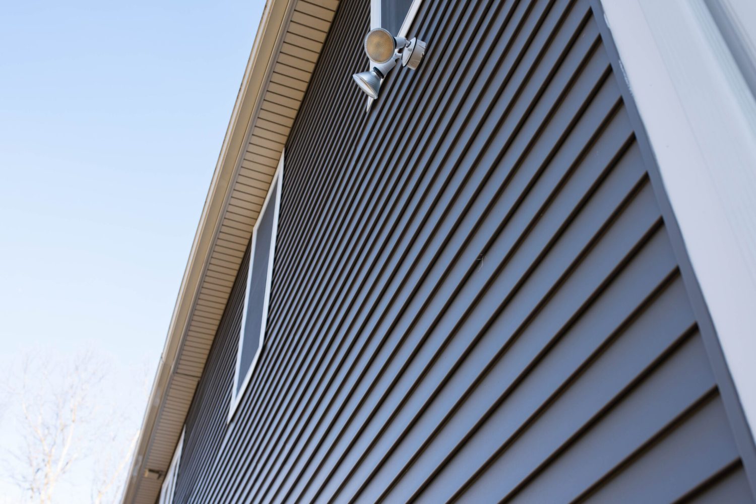 A wall of gray vinyl siding